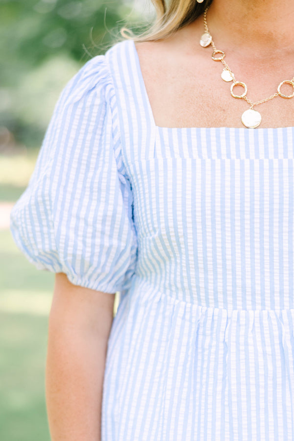 Plus Size blue and white striped seersucker top with puff sleeves and a square neckline.