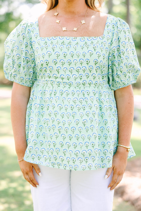 Plus Size green floral print top with a square neckline, puff sleeves, and a peplum waist.