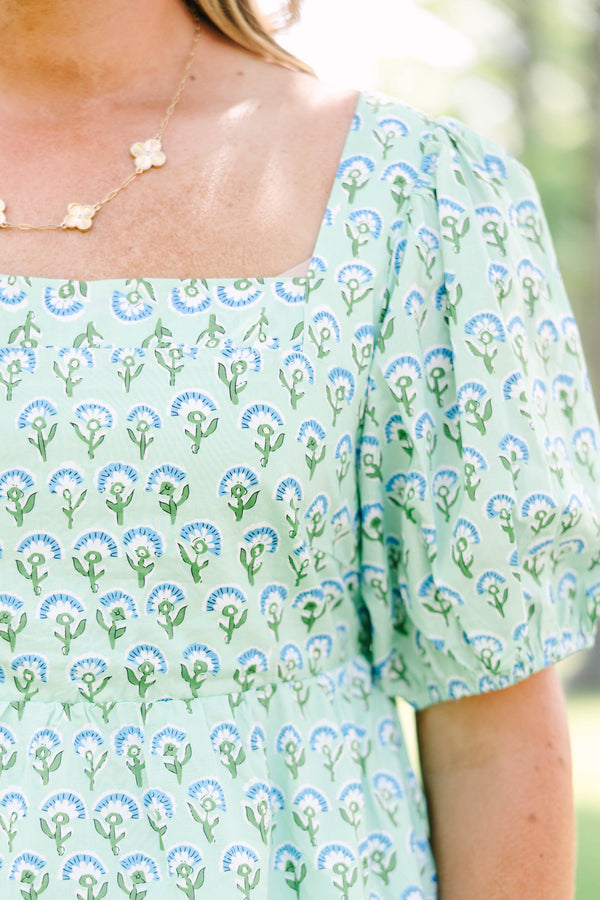 Plus Size green floral print top with a square neckline, puff sleeves, and a peplum waist.