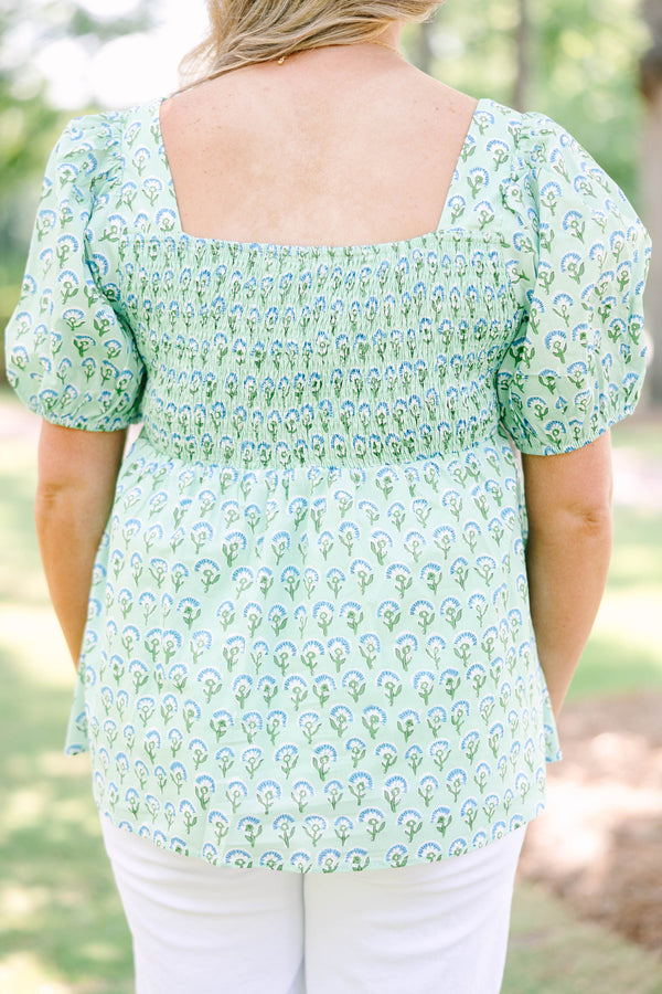 Plus Size green floral print top with a square neckline, puff sleeves, and a peplum waist.