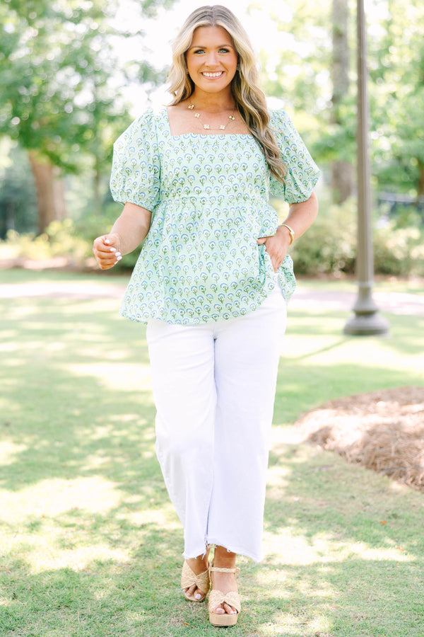 Plus Size green floral print top with a square neckline, puff sleeves, and a peplum waist.