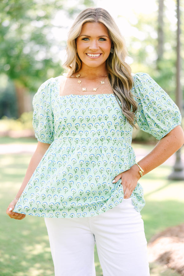 Plus Size green floral print top with a square neckline, puff sleeves, and a peplum waist.
