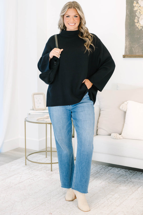 Plus Size black oversized knit sweater with a mock neckline and wide long sleeves.