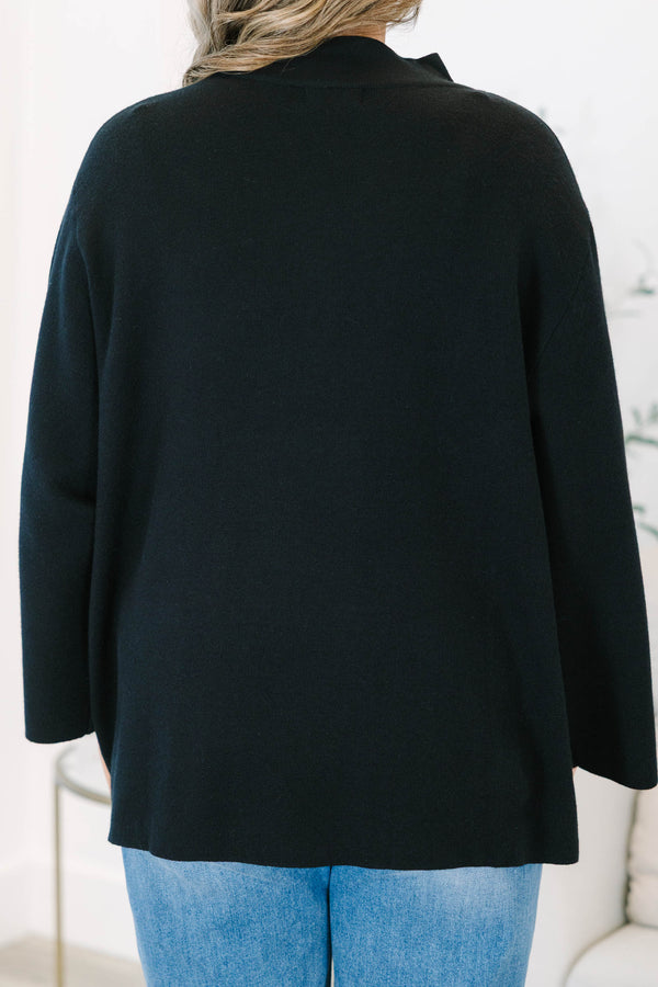 Plus Size black oversized knit sweater with a mock neckline and wide long sleeves.