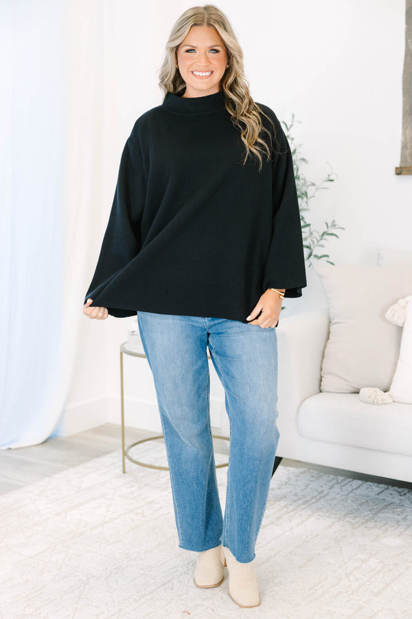 Plus Size black oversized knit sweater with a mock neckline and wide long sleeves.