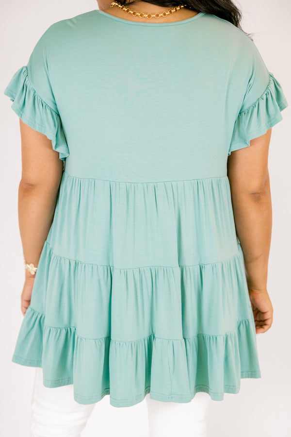 Plus Size teal tiered babydoll tunic with ruffled short sleeves and a round neckline.