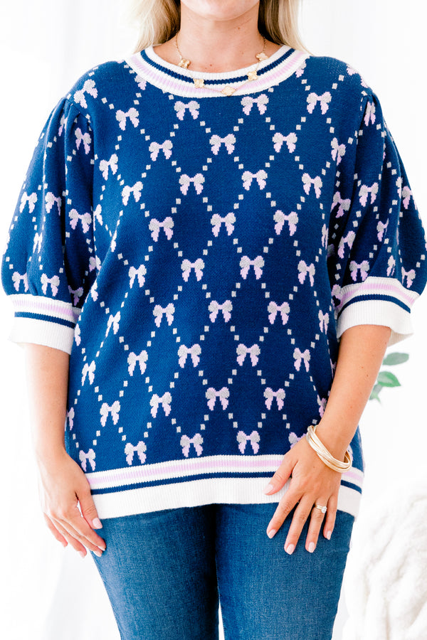 Chic Soul Plus size Clothing, Navy blue short sleeve sweater with a bow print throughout and a white cuff with a stripe on the ends of each sleeve and bottom of the shirt 
