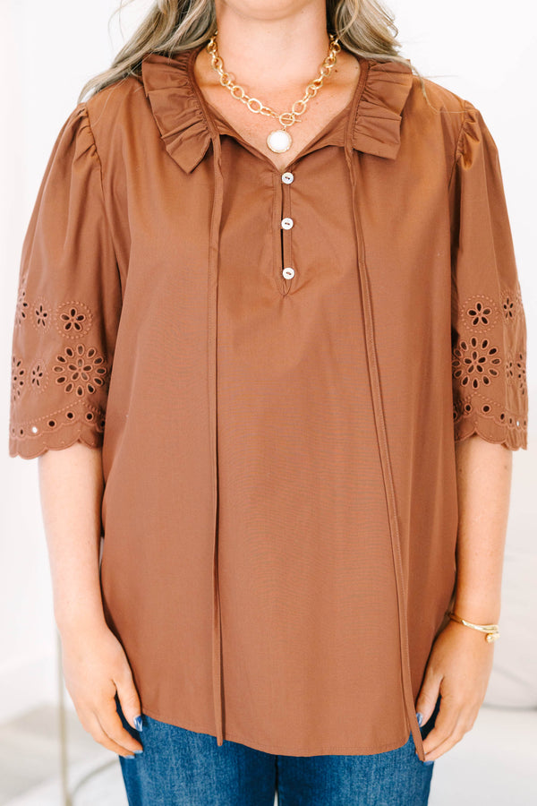 Plus Size brown short sleeve top with eyelet embroidery on the sleeves and a button-up neckline.