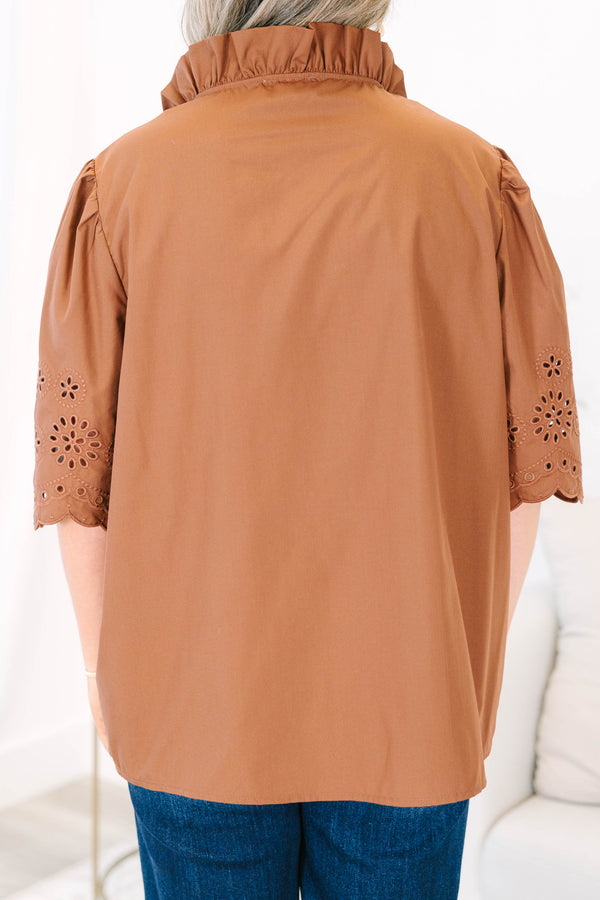 Plus Size brown short sleeve top with eyelet embroidery on the sleeves and a button-up neckline.