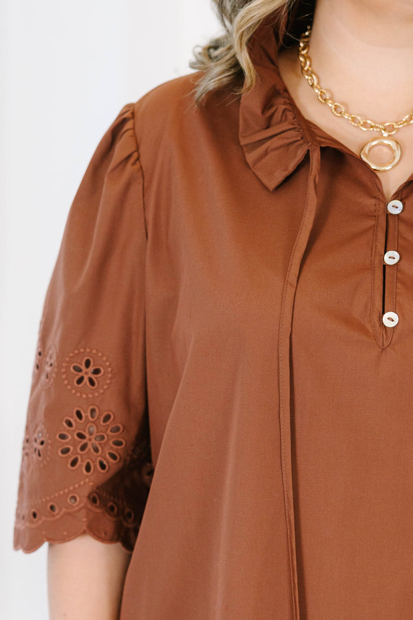 Plus Size brown short sleeve top with eyelet embroidery on the sleeves and a button-up neckline.