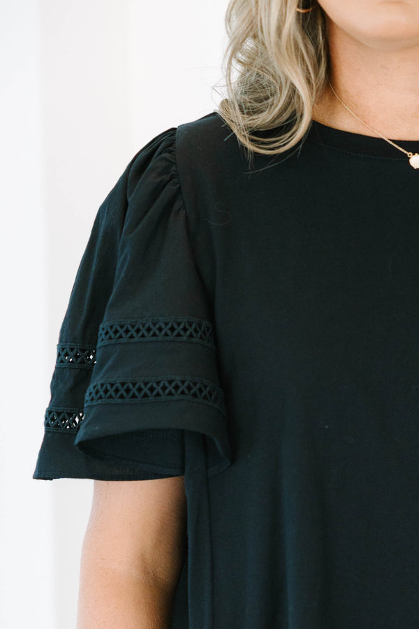 Plus size black 100% cotton top with flowy ruffle sleeves and crochet lace detailing.