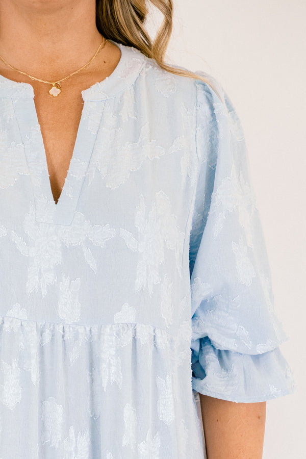 Chic Soul plus size clothing, baby blue tiered midi dress with half sleeves that that have a ruffle detail at the end of each sleeve as well a slight v-neckline and subtle floral pattern 