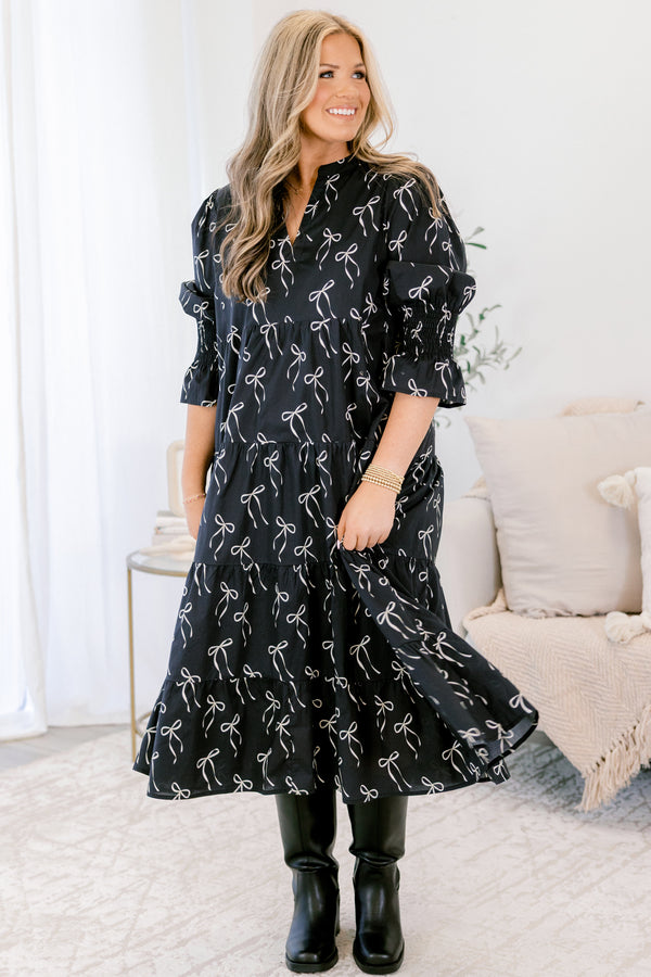 Chic Soul plus suze clothing, black midi dress with mid sleeves and v-neckline and white bow pattern