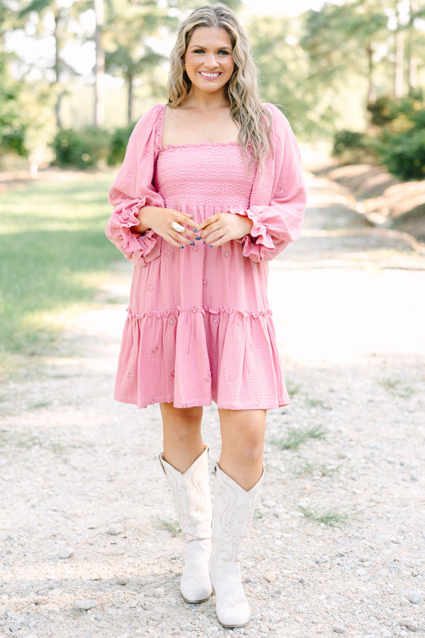 Plus size pink cotton dress with smocked bodice, long puff sleeves, and floral embroidery.