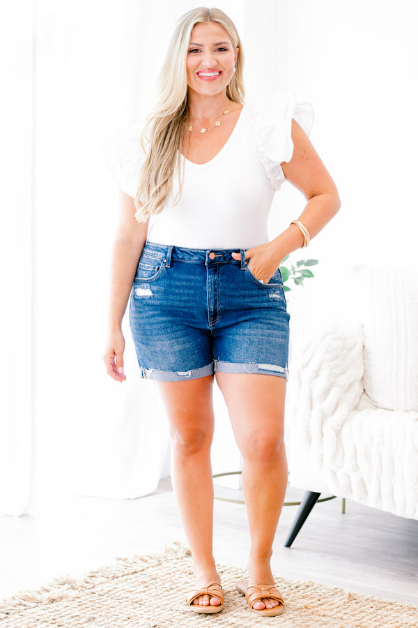 Chic Soul Plus size clothing, dark wash jean shorts with front pockets and a cuff at the bottom of each leg of the shorts