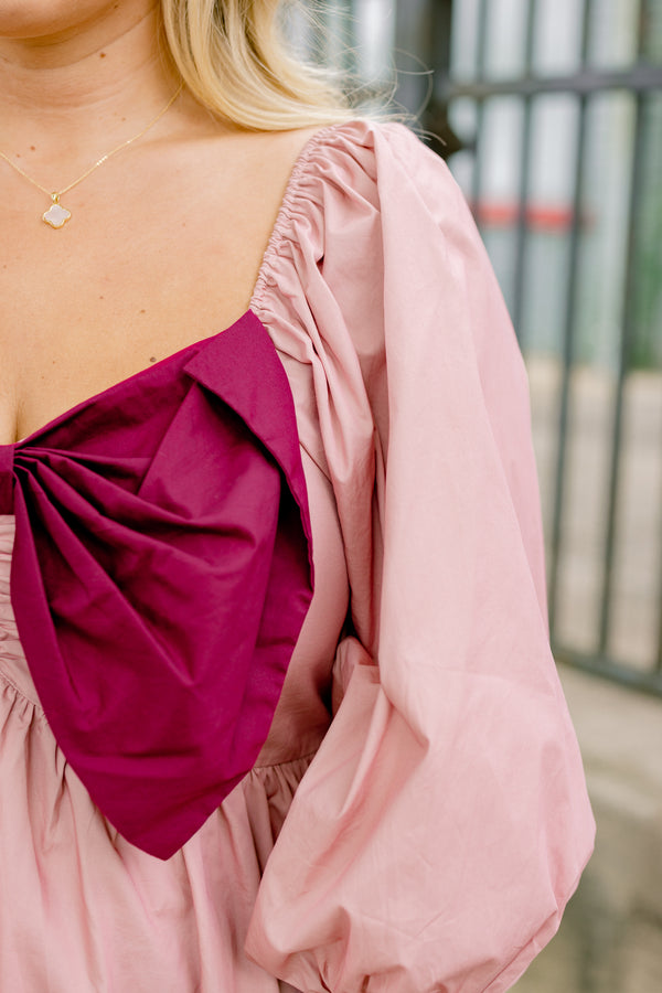 Chic Soul plus size clothing, light pink long sleeve babydoll top with an oversized maroon bow on the chest