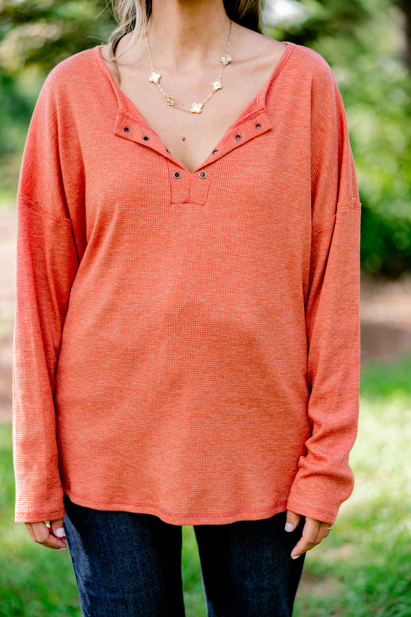 Chic Soul plus size clothing, rust red long sleeve top with buttons ¼ of the way down the top that is relaxed in fit with a scoop hem
