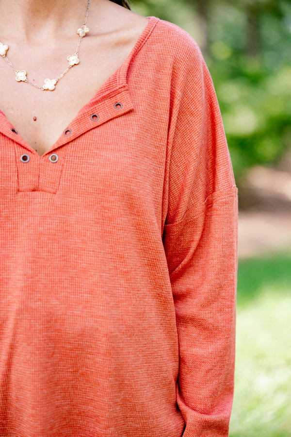 Chic Soul plus size clothing, rust red long sleeve top with buttons ¼ of the way down the top that is relaxed in fit with a scoop hem
