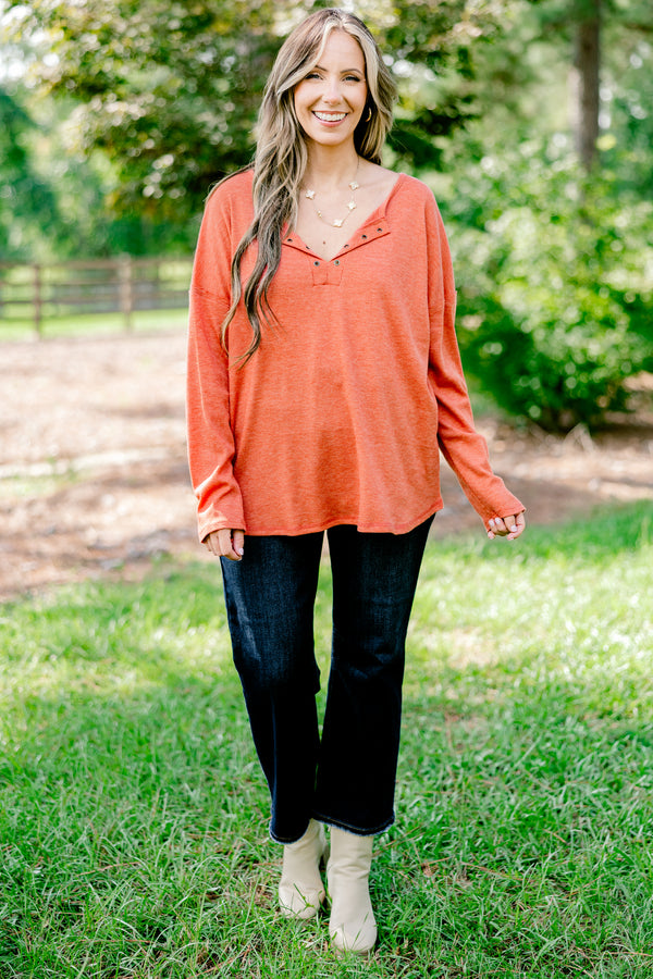 Chic Soul plus size clothing, rust red long sleeve top with buttons ¼ of the way down the top that is relaxed in fit with a scoop hem
