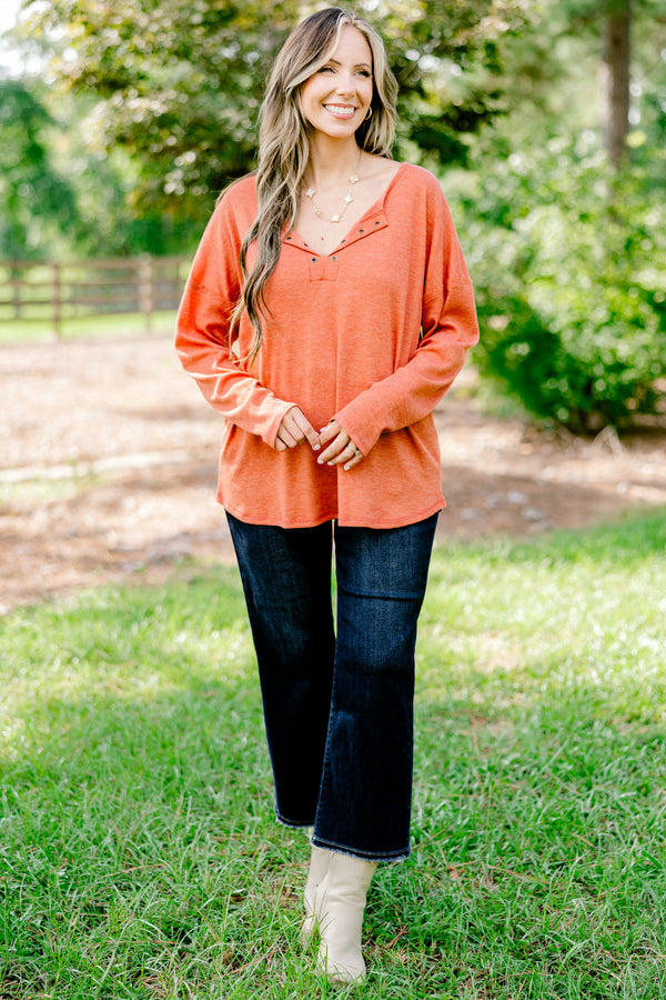 Chic Soul plus size clothing, rust red long sleeve top with buttons ¼ of the way down the top that is relaxed in fit with a scoop hem
