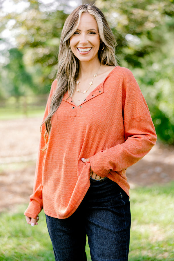 Chic Soul plus size clothing, rust red long sleeve top with buttons ¼ of the way down the top that is relaxed in fit with a scoop hem
