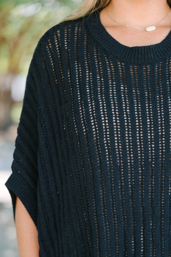 Plus Size black open-knit poncho sweater with a crew neckline and short, wide sleeves.