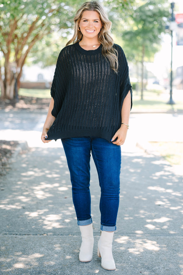 Plus Size black open-knit poncho sweater with a crew neckline and short, wide sleeves.