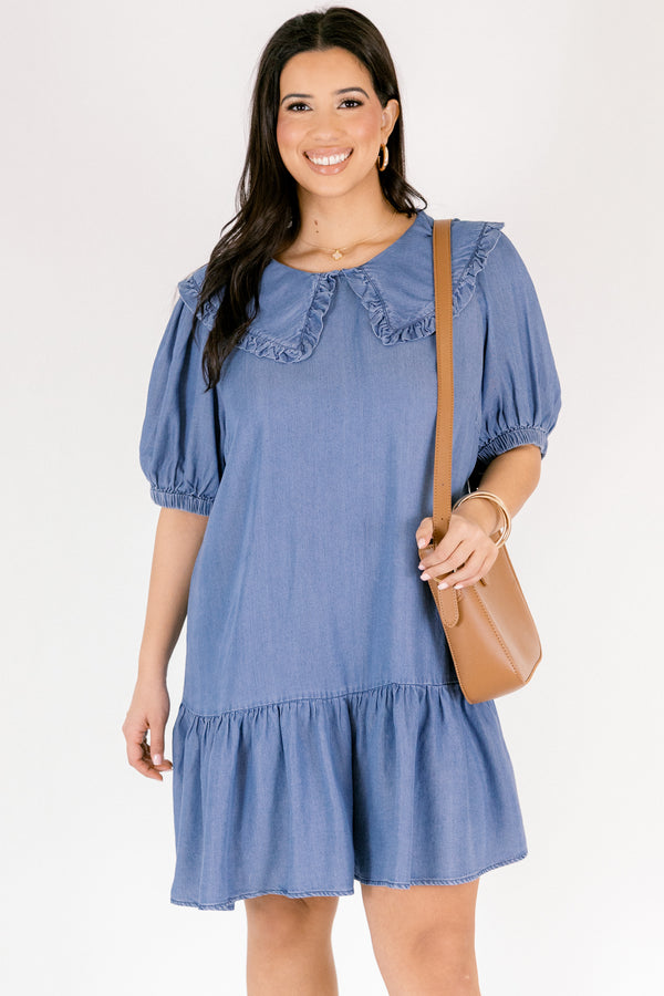 Chic Soul plus size clothing, Denim knee length dress with bubble sleeves and a bib collar that has ruffle detailing going along the edge of the bib as well as a ruffle detail on the bottom tier of the dress 
