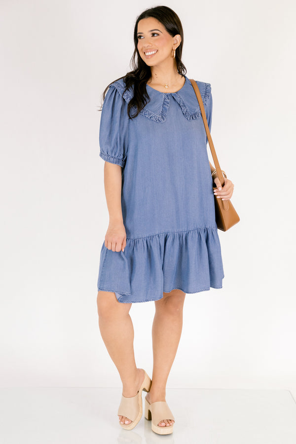 Chic Soul plus size clothing, Denim knee length dress with bubble sleeves and a bib collar that has ruffle detailing going along the edge of the bib as well as a ruffle detail on the bottom tier of the dress 
