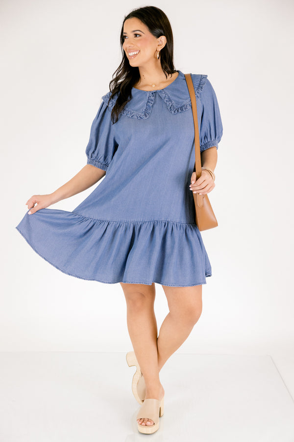 Chic Soul plus size clothing, Denim knee length dress with bubble sleeves and a bib collar that has ruffle detailing going along the edge of the bib as well as a ruffle detail on the bottom tier of the dress 
