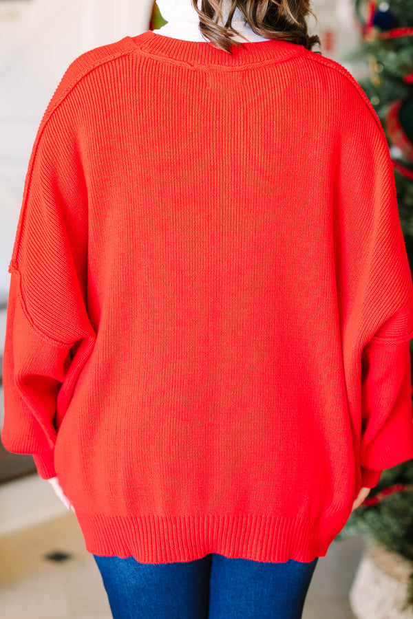 Plus size red oversized knit sweater with a crew neck and relaxed fit.