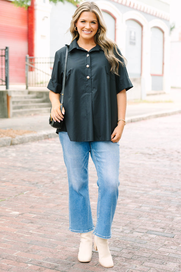 Plus Size black short sleeve top with a collar and gold starburst buttons.