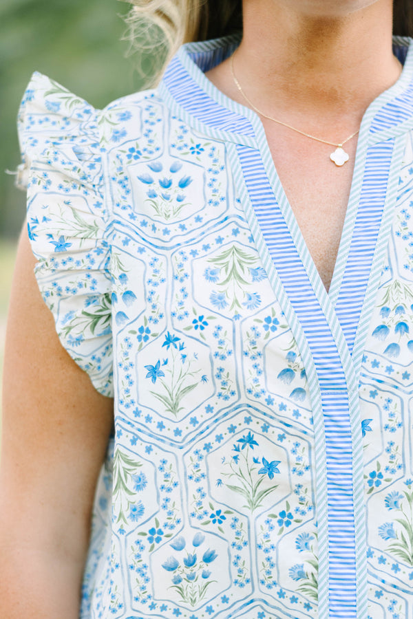 Plus Size blue and white floral print top with ruffle cap sleeves and a striped V-neckline.