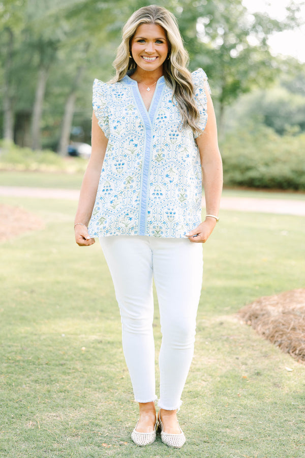 Plus Size blue and white floral print top with ruffle cap sleeves and a striped V-neckline.