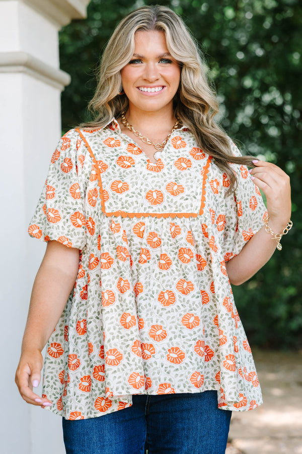 Plus Size floral babydoll top in burnt orange and green with a square yoke and short puff sleeves.