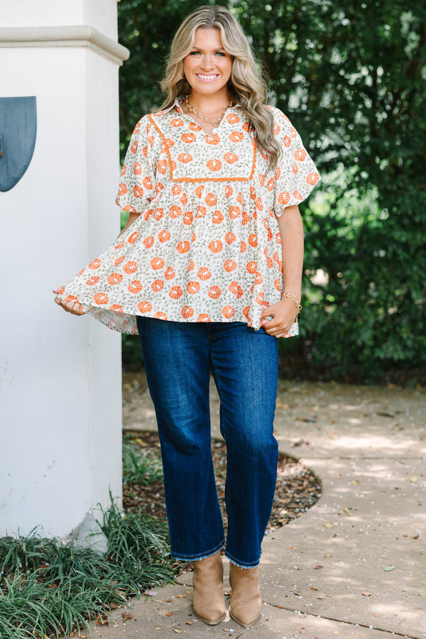 Plus Size floral babydoll top in burnt orange and green with a square yoke and short puff sleeves.