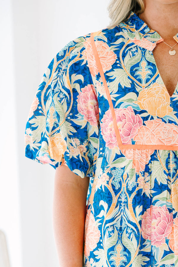 Plus Size blue floral babydoll top with puff sleeves, a notched neckline, and orange trim.