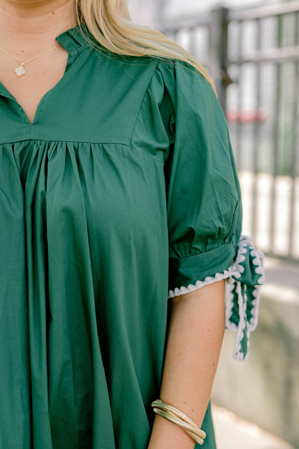 Chic Soul plus size clothing, dark green short puff sleeve flowy dress with white embroidered ties on the sleeves in bows
