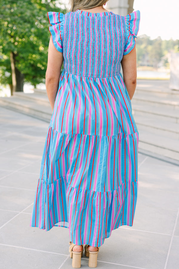 Plus Size blue tiered maxi dress with multi-colored stripes, smocked bodice, and flutter sleeves.