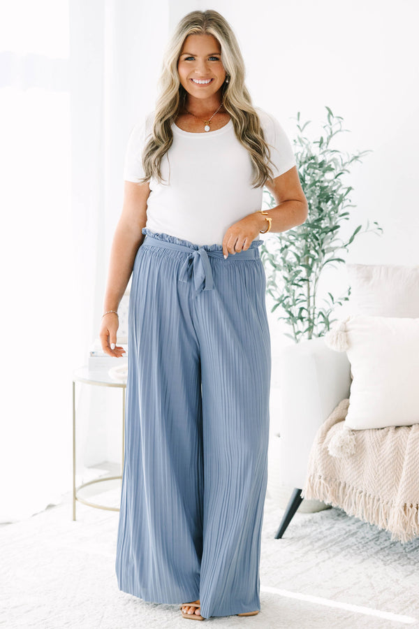 Plus Size blue pleated wide-leg pants with a high-waisted elastic tie-waist and ruffle trim.