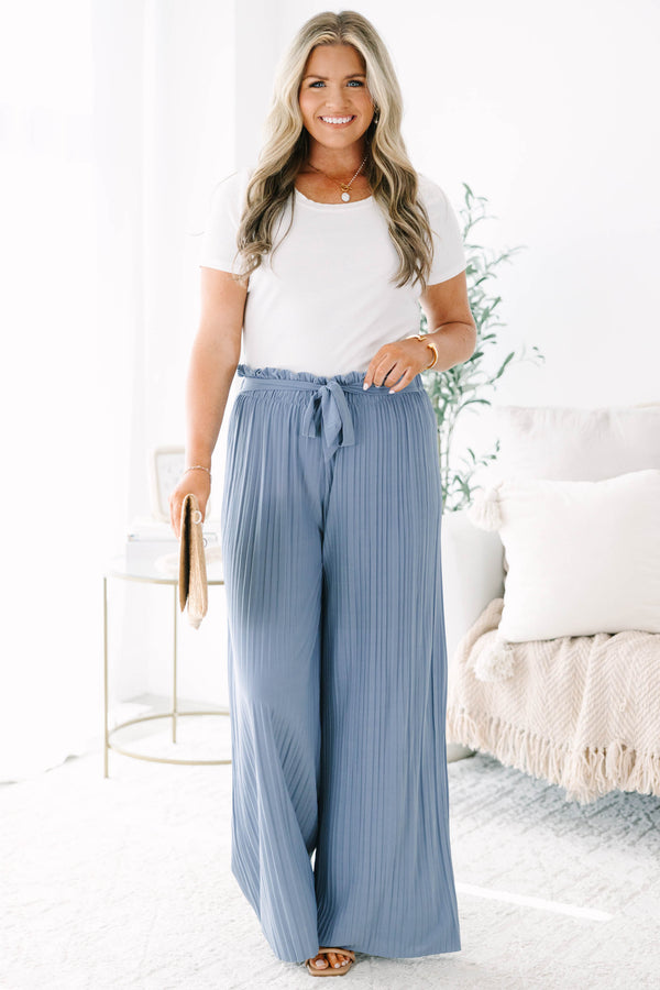Plus Size blue pleated wide-leg pants with a high-waisted elastic tie-waist and ruffle trim.