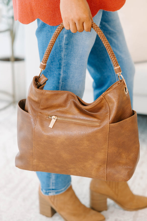 Plus Size brown faux leather tote bag with braided handle and side pocket details.