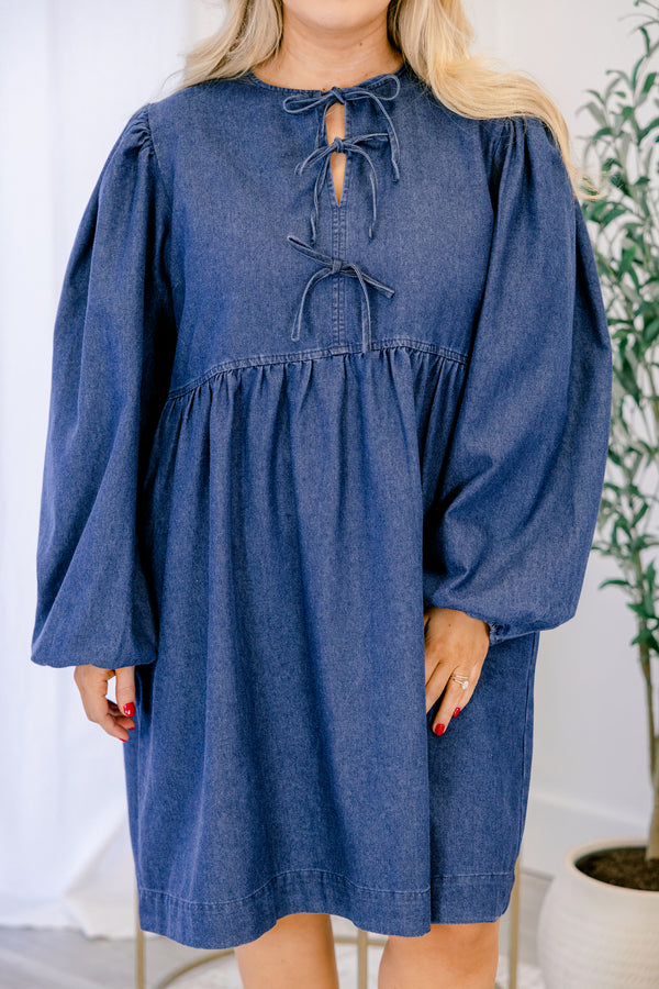 Chic Soul plus size clothing, dark wash denim long puff sleeve knee length baby doll dress with v neck cutout and strings tying in 3 bows down the collar