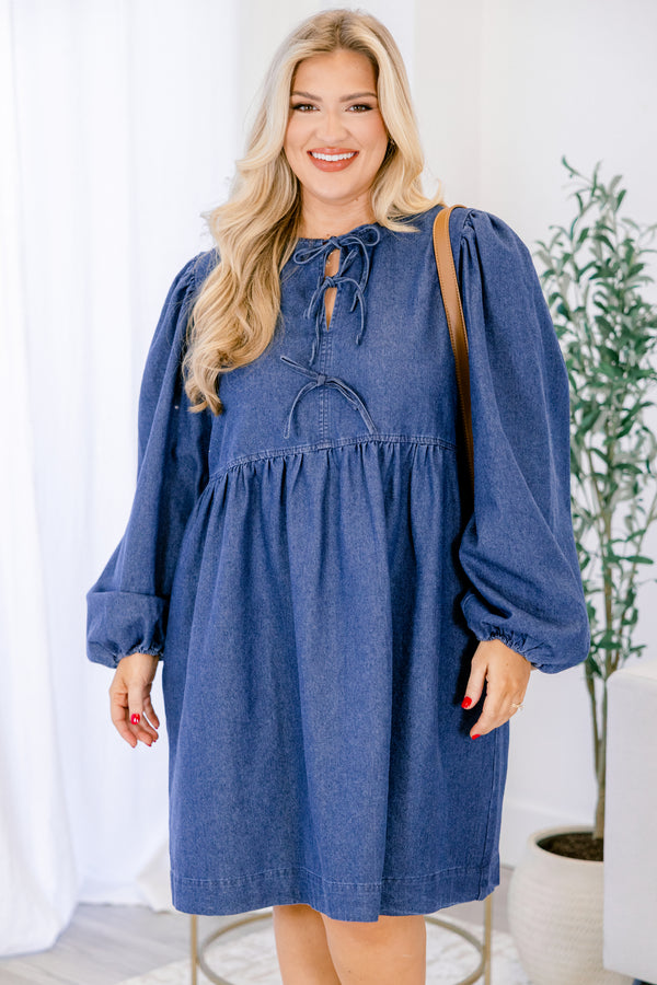 Chic Soul plus size clothing, dark wash denim long puff sleeve knee length baby doll dress with v neck cutout and strings tying in 3 bows down the collar