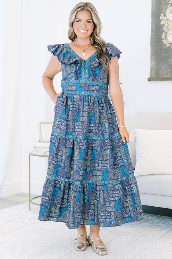 Plus Size purple and blue patterned tiered maxi dress with ruffle cap sleeves and a V-neckline.