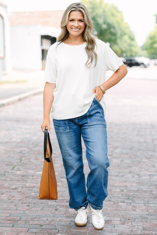 Plus Size medium wash high-rise cargo jogger jeans with front patch pockets and elasticized cuffs.