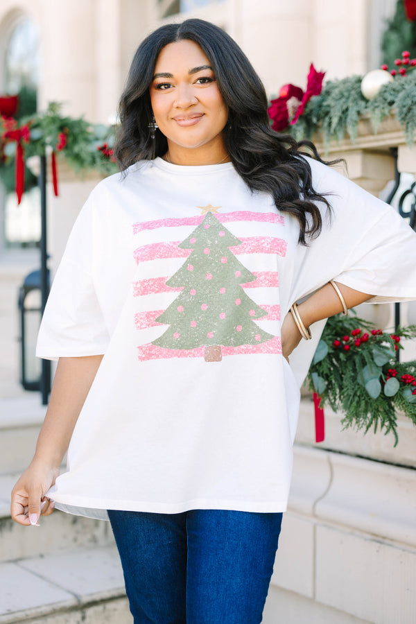 Plus Size white boyfriend tee with a green Christmas tree graphic and pink striped background.