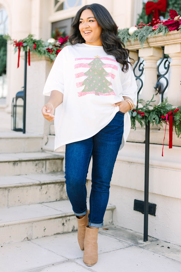 Plus Size white boyfriend tee with a green Christmas tree graphic and pink striped background.