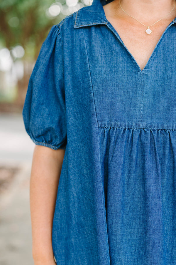 Plus size dark denim tiered maxi dress with a flowy fit, V-neckline, and short puff sleeves.