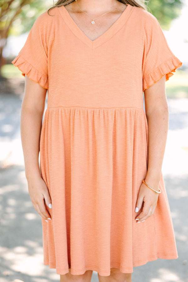 Plus size marmalade orange dress with a flowy babydoll fit, V-neckline, and ruffle sleeve details.